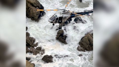 A California Highway Patrol helicopter navigated the rugged coastline to rescue two occupants of the car.