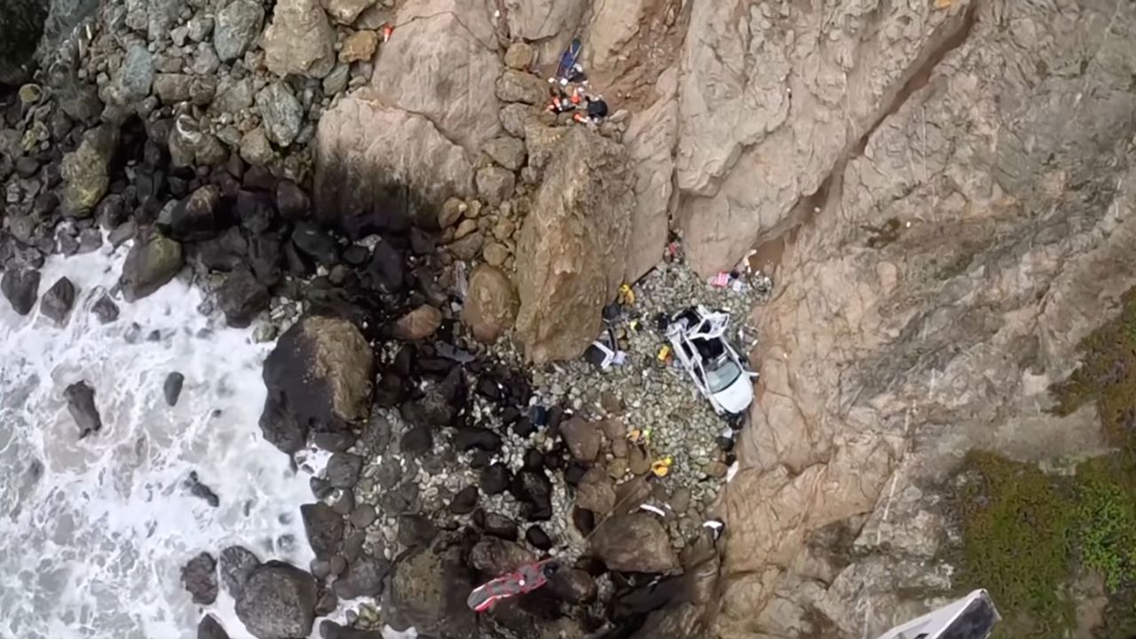 "This morning, CHP H-30 responded with multiple fire agencies from San Mateo County, CAL FIRE CZU San Mateo-Santa Cruz Unit, American Medical Response - San Mateo County, CHP - San Francisco, the United States Coast Guard and the San Mateo County Sheriff's Office to a report of a " vehicle over the cliff" at Devils Slide. 
As first responders arrived at the scene, it was determined that 2 adults and 2 children were trapped in a Tesla. While H-30 responded, firefighters rappelled to the scene and rescued the two children.  
CHP H-30 lowered a El Cerrito Fire Helicopter Rescue Technician (HRT) to the scene who assisted in the extrication and rescue of two adults.  
CHP H-30 hoisted both adults from the waters edge and transferred them to a waiting Stanford Life Flight Helicopter. "
