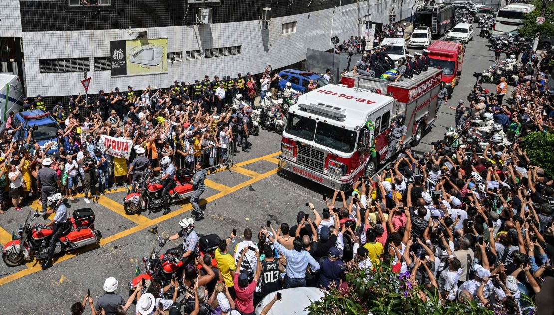 Pelé's coffin is being taken through the streets on a firetruck.