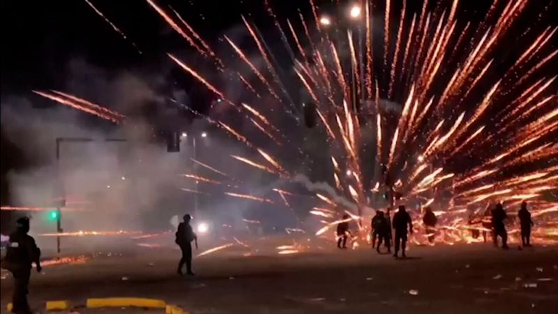 Video: Fireworks launched towards police in protests | CNN