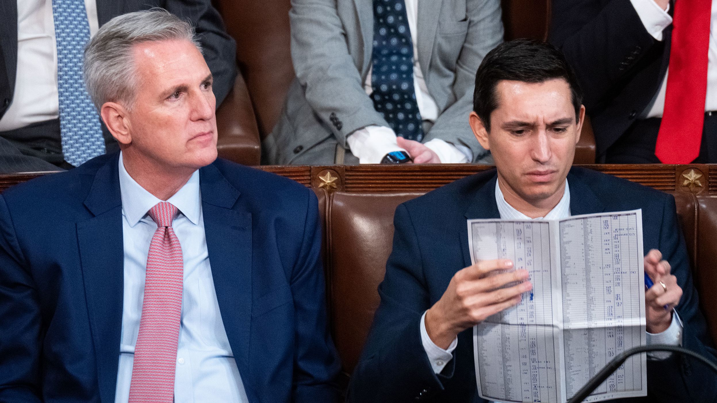 McCarthy and an aide wait for a final tally of votes as the House meets to elect a new speaker in January 2023. McCarthy lost 14 votes over four days before he eventually secured the support he needed to win the speakership.