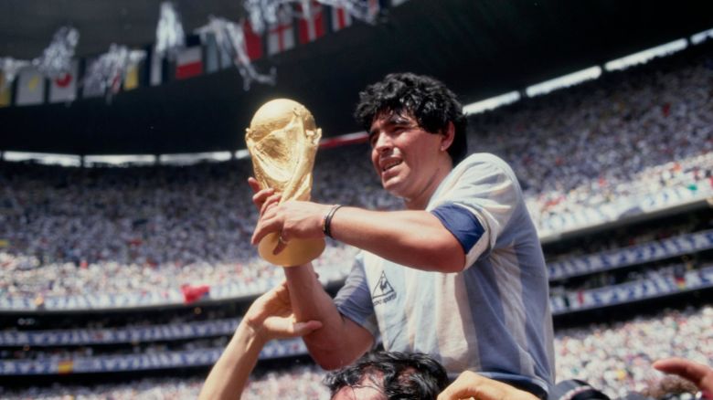 Argentine professional football player Diego Armando Maradona (1960 - 2020) holds the World Cup trophy after Argentina defeated West Germany 3-2 during the 1986 FIFA World Cup Final match at the Azteca Stadium in  Mexico City, Mexico, 29th June 1986. (Photo by Bongarts/Getty Images)