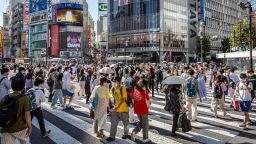 People wearing face masks cross Shibuya crossing on July 29, 2022 in Tokyo, Japan. The World Health Organization (WHO) announced that Japan's COVID-19 cases between July 18 to 24 reached 970,000, the highest in the world. 