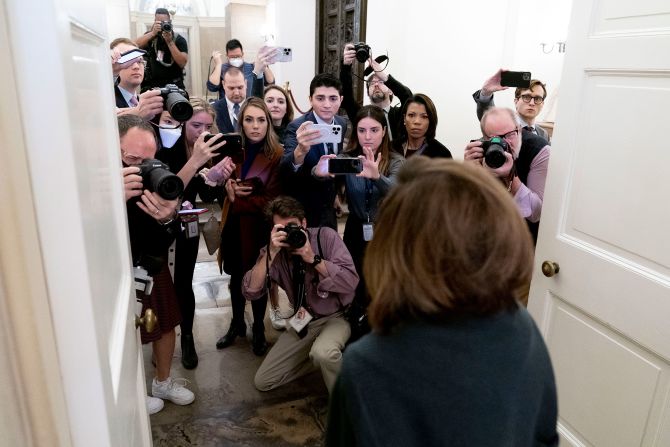 Pelosi, seen in the foreground, talks to reporters as she arrives at the Capitol on Wednesday. Pelosi told CNN that <a href="index.php?page=&url=https%3A%2F%2Fwww.cnn.com%2Fpolitics%2Flive-news%2Fhouse-speaker-leadership-vote-1-4-23%2Fh_96c351092e6346e420fc760e2c9ec32f" target="_blank">House of Representatives members should be sworn in</a> — even if a speaker is not chosen yet — so their families can witness the moment and not have to wait around the Capitol all day.