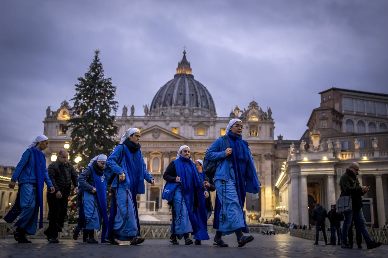 Nuns arrive at dawn to view Benedict's body on Tuesday.
