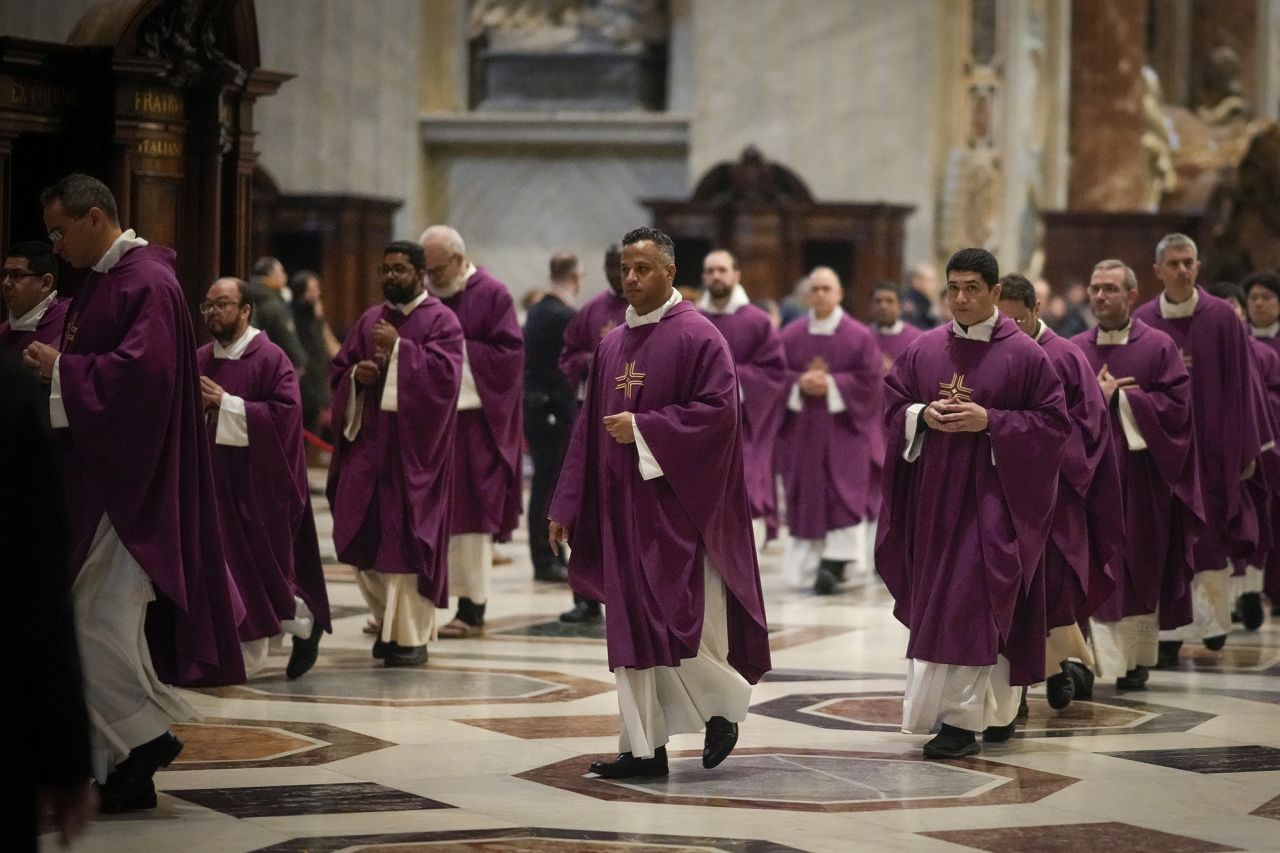 Priests process through St. Peter's Basilica as Benedict lies in state on Tuesday, January 3.