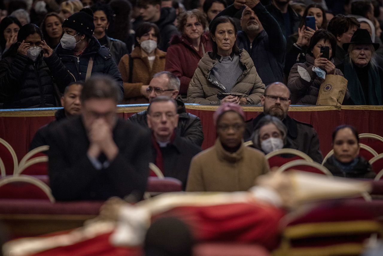 Mourners watch over the body of Pope Emeritus Benedict XVI as he lies in state inside St. Peter's Basilica on Wednesday, January 4.