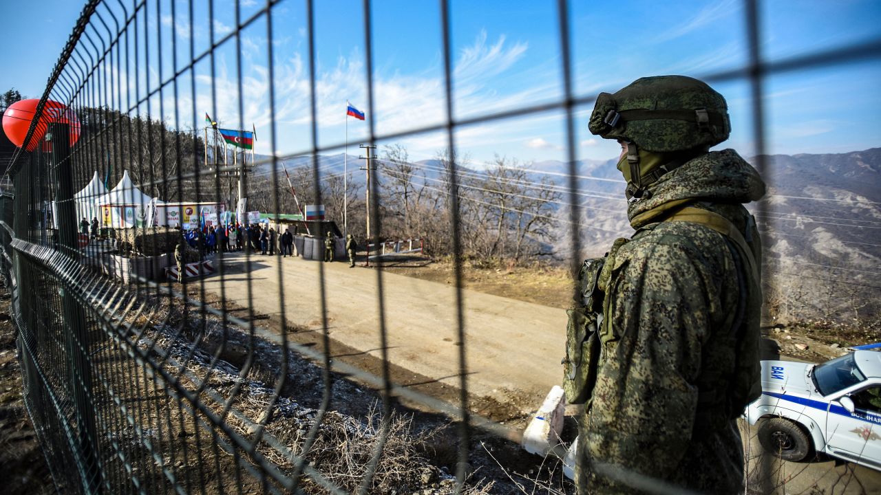 A Russian peacekeeper guards the Lachin Corridor, which has been blocked by Azerbaijani protesters since December 12, 2022 -- cutting off ethnic Armenians of Nagorno-Karabakh from the outside world.