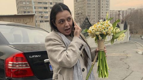 Iranian prominent actress Taraneh Alidoosti speaks on a cellphone as she holds bunches of flowers after being released from Evin prison in Tehran, Iran, on Wednesday, January 4, 2023.