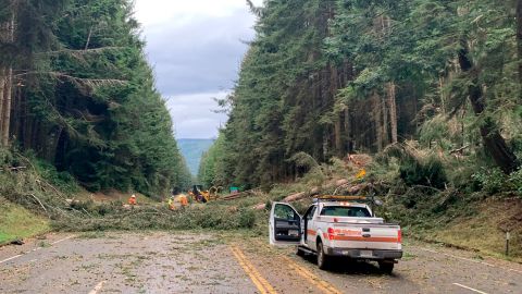 Crews work at removing multiple fallen trees blocking U.S. Highway 101 in Humboldt County near Trinidad, California, on Wednesday, January 4, 2022.