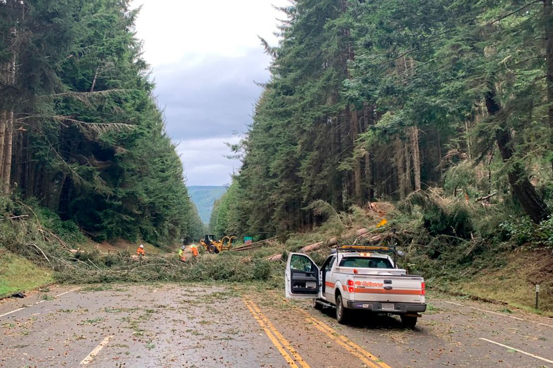 Crews work at removing multiple fallen trees blocking U.S. Highway 101 in Humboldt County near Trinidad, California, on Wednesday, January 4, 2022.