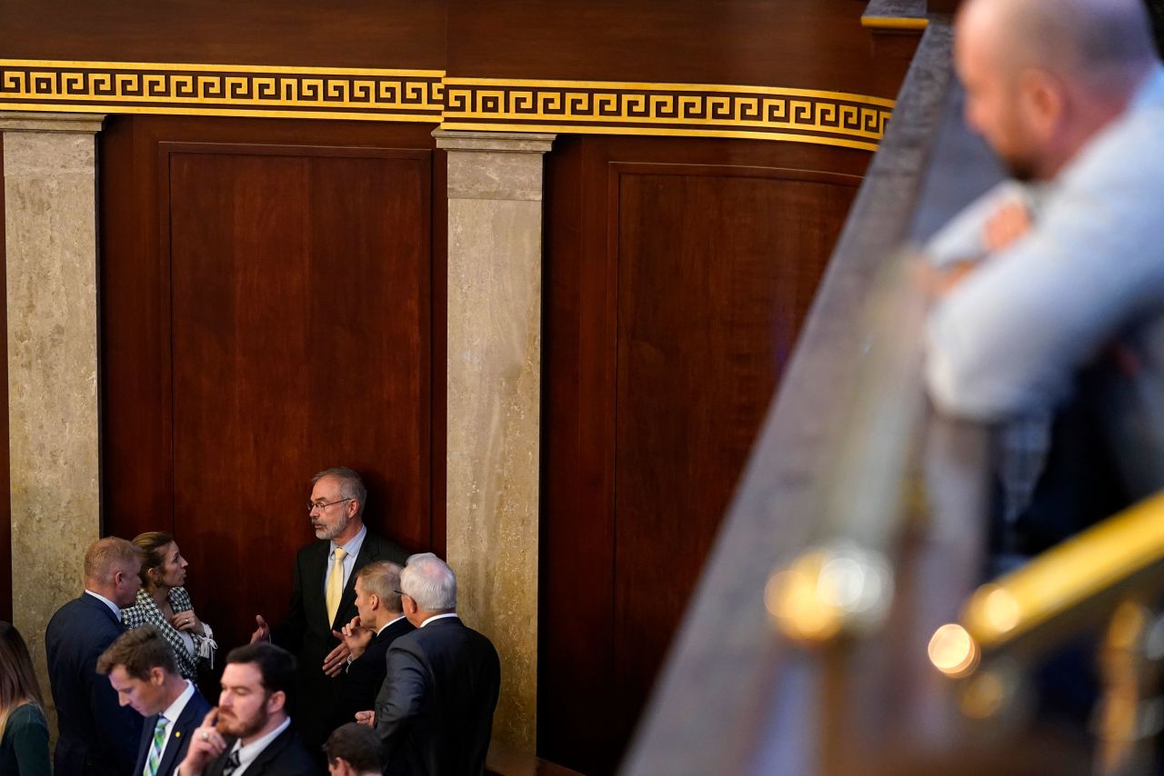 Members of the House have discussions inside the chamber on Wednesday.