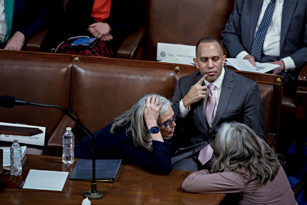 Jeffries, a Democrat from New York who will become the first Black lawmaker to lead a party in Congress, watches Rep. Katherine Clark, a Democrat from Massachusetts, have a conversation on Wednesday.