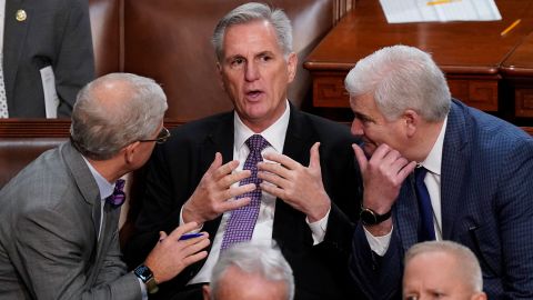 Rep. Patrick McHenry, left, and Rep. Tom Emmer speak with McCarthy in the House chamber on January 4, 2023, as lawmakers meet for a second day to elect a speaker and convene the 118th Congress.