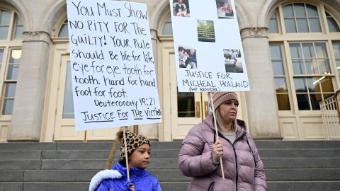 Nine-year-old Lyric Jones and her mother, Teran Christian, stand outside the courthouse in Grand Junction, Colorado, on Tuesday. Christian's grandfather was one of the victims at Sunset Mesa Funeral Home.