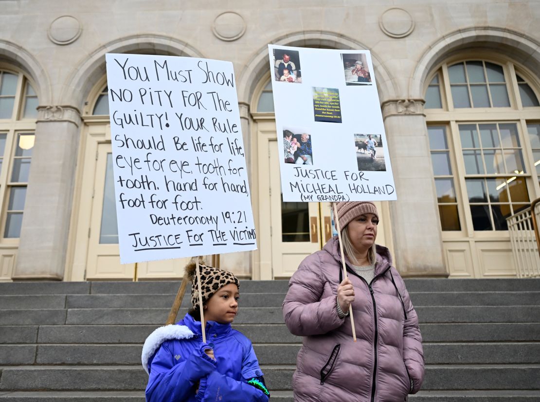 Nine-year-old Lyric Jones and her mother, Teran Christian, stand outside the courthouse in Grand Junction, Colorado, on Tuesday. Christian's grandfather was one of the victims at Sunset Mesa Funeral Home.