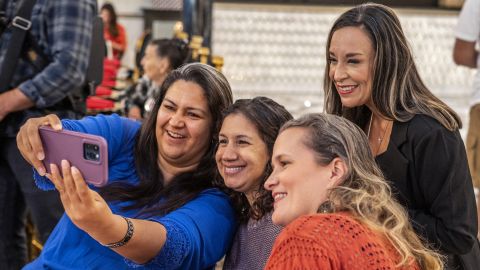 De La Cruz takes a selfie with supporters in McAllen, Texas, in October 2022. 
