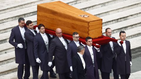 Benedict's coffin is carried through St Peter's Square.