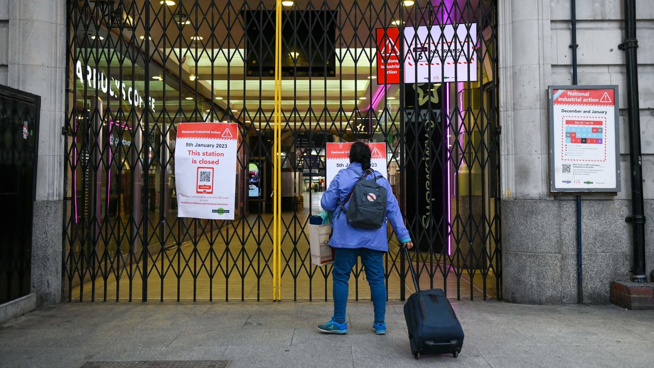 A traveler approaches closed gates at an entrance to London Victoria railway station on Thursday, Jan. 5 2023.