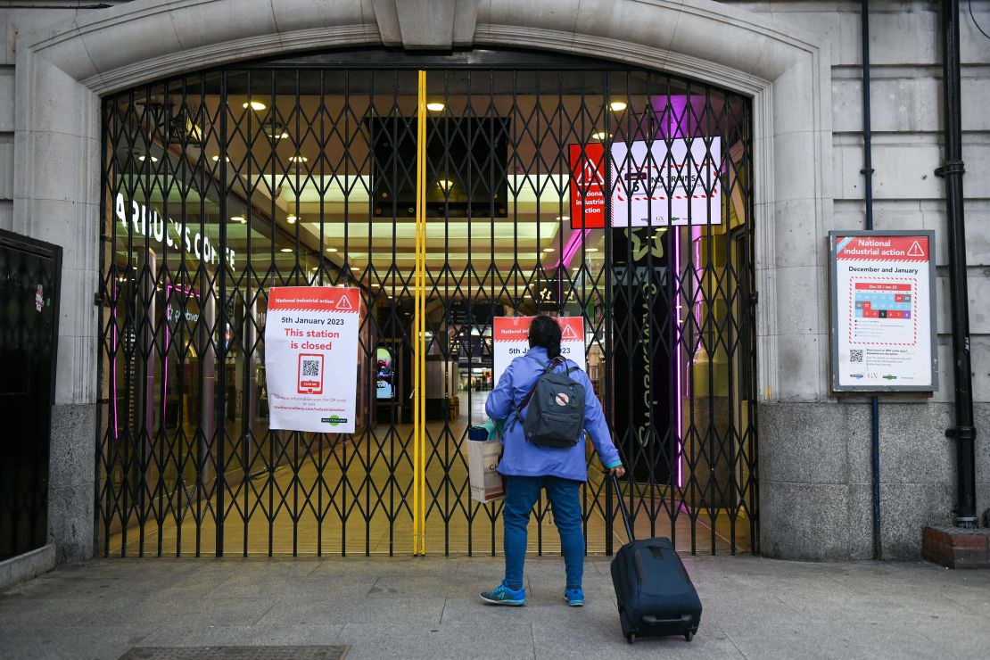 A traveler approaches closed gates at an entrance to London Victoria railway station on Thursday, Jan. 5 2023.