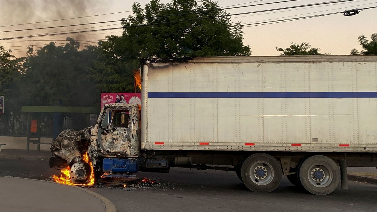 A burning truck is seen across a street during an operation to arrest Guzmán.
