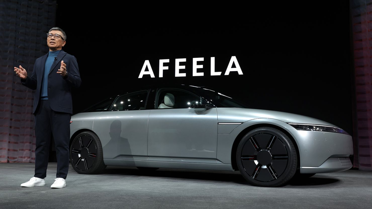 Sony Honda Mobility CEO Yasuhide Mizuno in front of an Afeela concept vehicle during a press event at CES 2023 at the Mandalay Bay Convention Center on January 04, 2023 in Las Vegas, Nevada. 