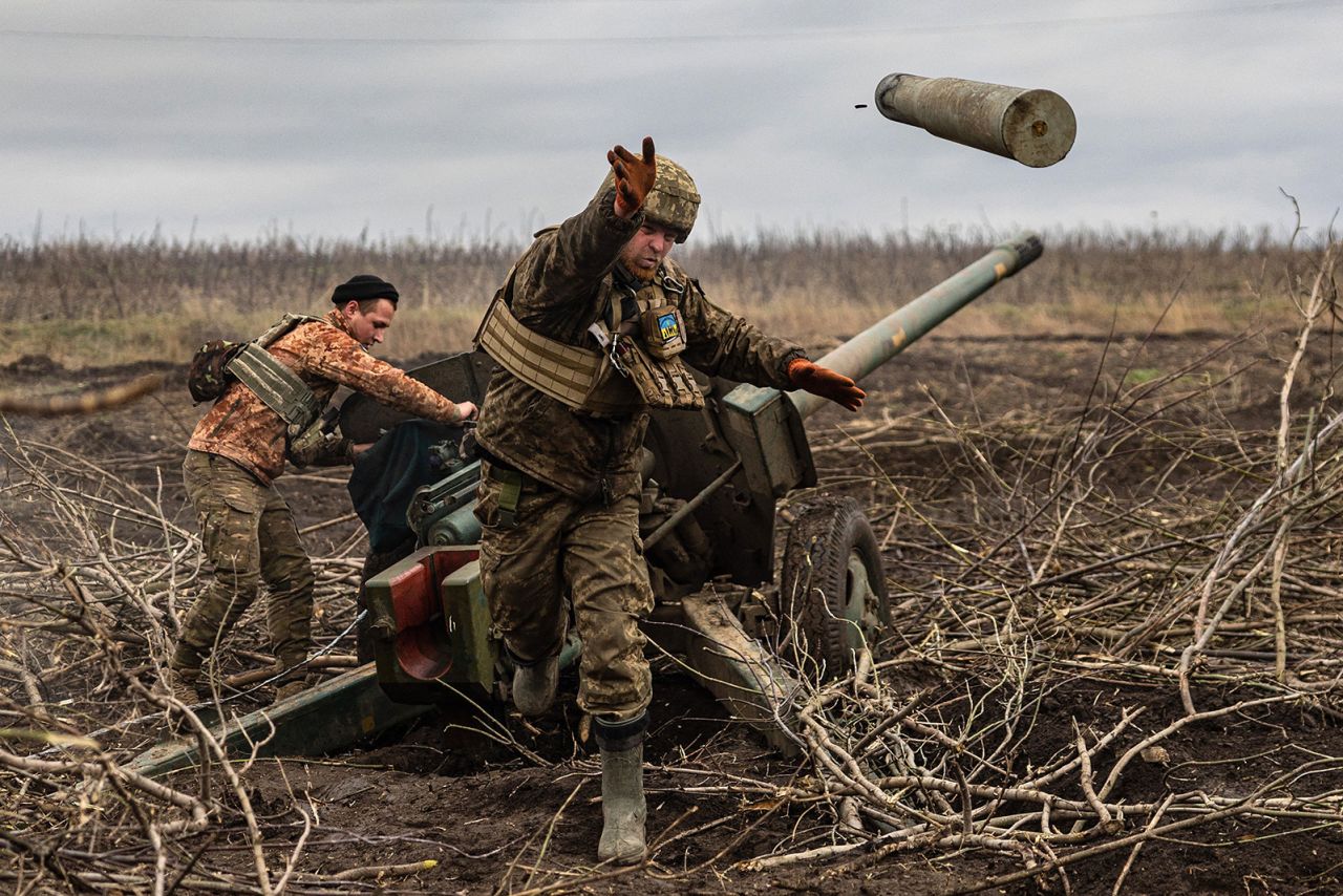 A Ukrainian serviceman throws an empty artillery shell while firing toward Russian positions on the outskirts of Bakhmut, Ukraine, on Friday, December 30.