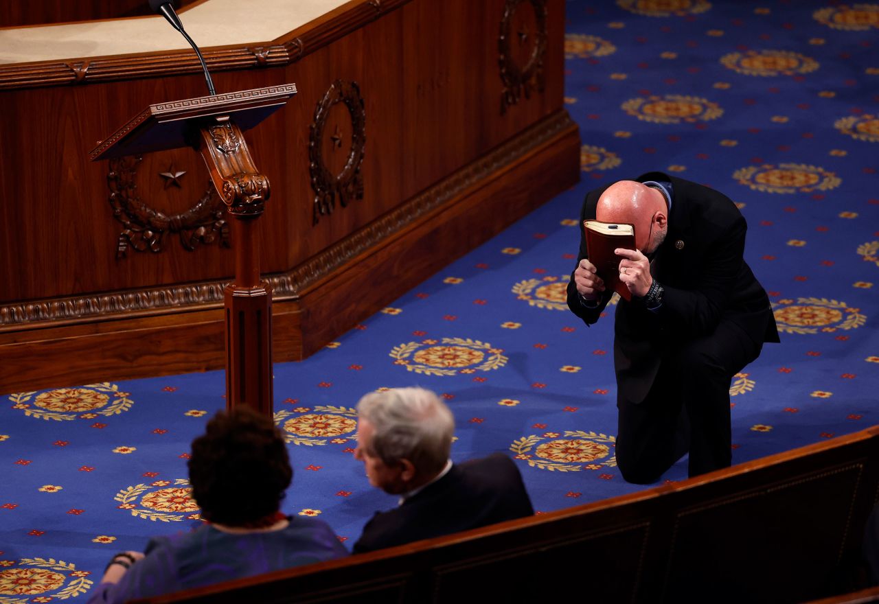 US Rep. Clay Higgins, a Republican from Louisiana, prays in the House chamber on Thursday.