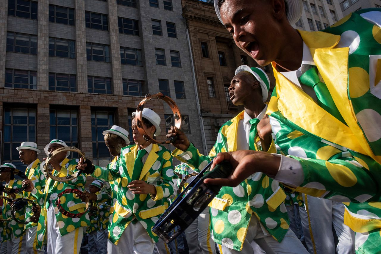 Performers play music, sing and dance as they take part in the Minstrel Carnival in Cape Town, South Africa, on Monday, January 2. About 20,000 performers, divided into dozens of troupes, marched in the city center. The celebration was returning after a two-year hiatus due to the Covid-19 pandemic.