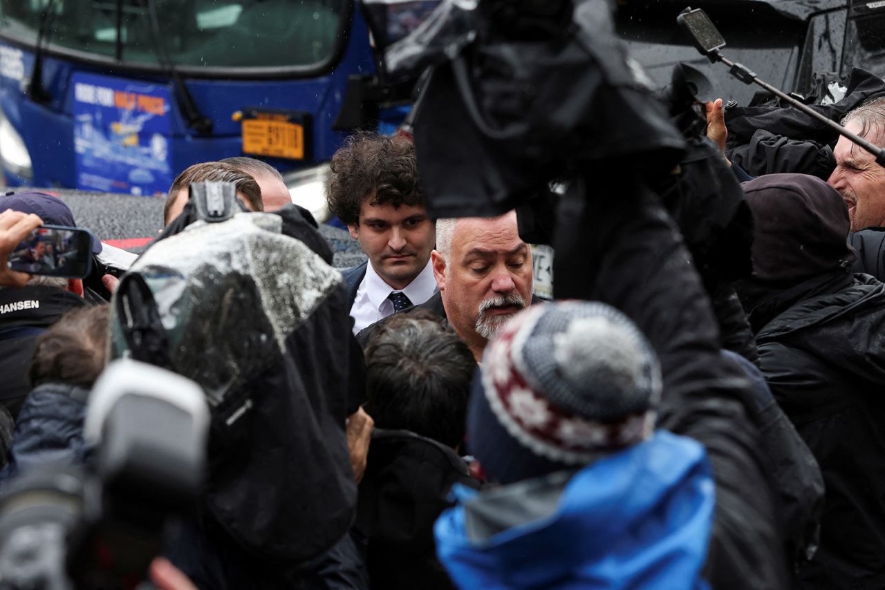 Sam Bankman-Fried, center left, walks to a federal courthouse in New York City on Tuesday, January 3. Bankman-Fried, the founder of bankrupt crypto exchange FTX, <a href="https://www.cnn.com/2023/01/03/business/sam-bankman-fried-plea/index.html" target="_blank">pleaded not guilty</a> to two counts of wire fraud and six counts of conspiracy-related charges.