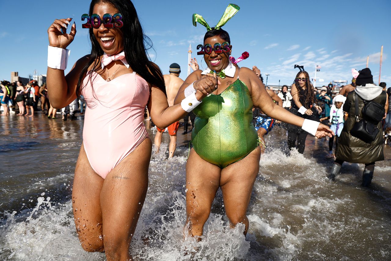 People run into the Atlantic Ocean off New York's Coney Island as part of a New Year's Day Polar Bear Plunge.