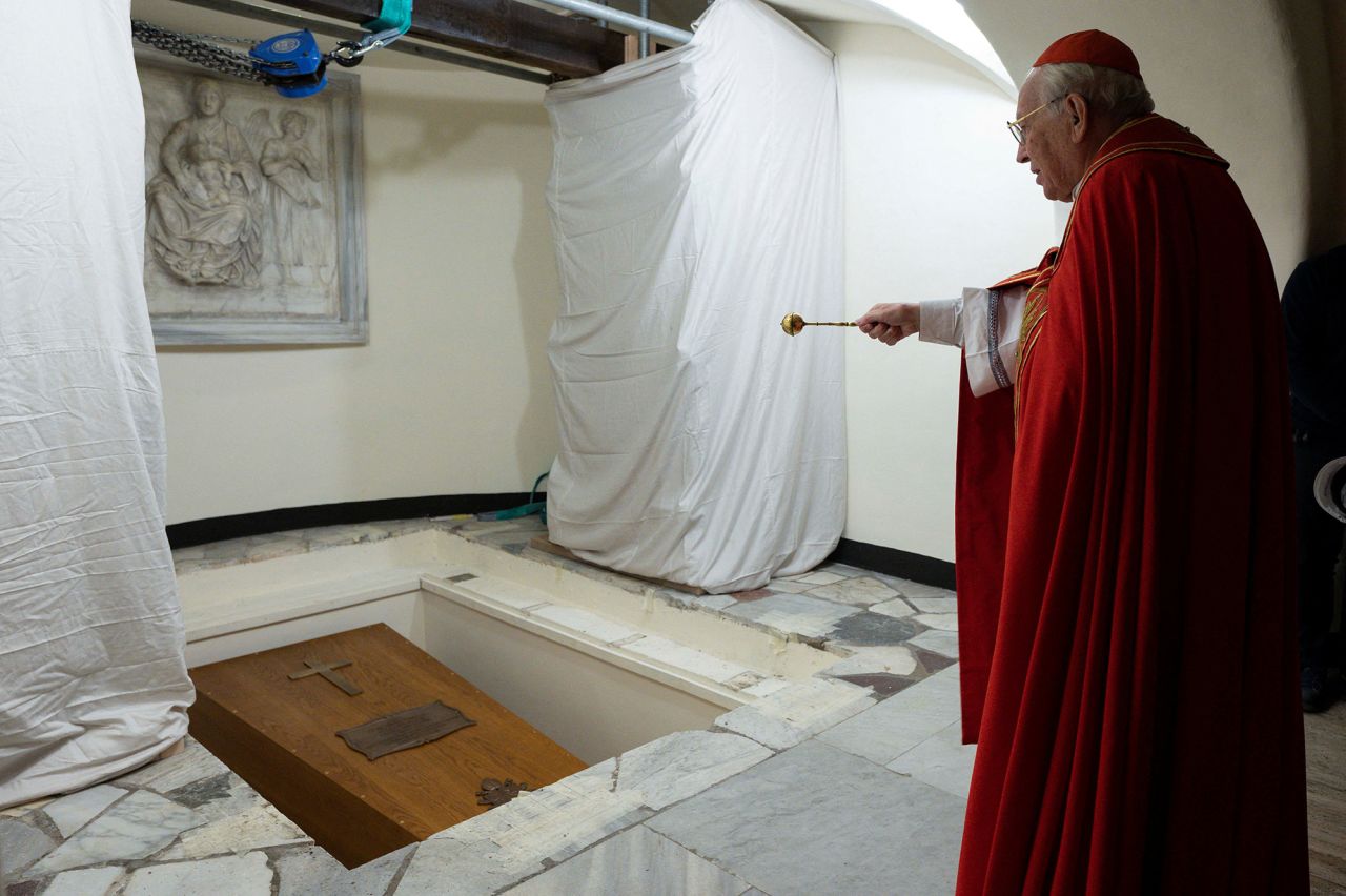 Cardinal Giovanni Battista Re blesses the coffin of former Pope Benedict in The Holy Grotto of the Vatican.