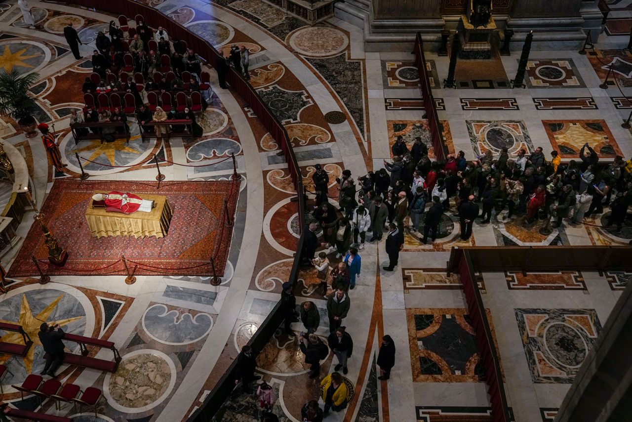 People queue to see off late Pope Emeritus Benedict XVI lying out in state inside St. Peter's Basilica at The Vatican where thousands went to pay their homage Tuesday, Jan 3, 2023. 