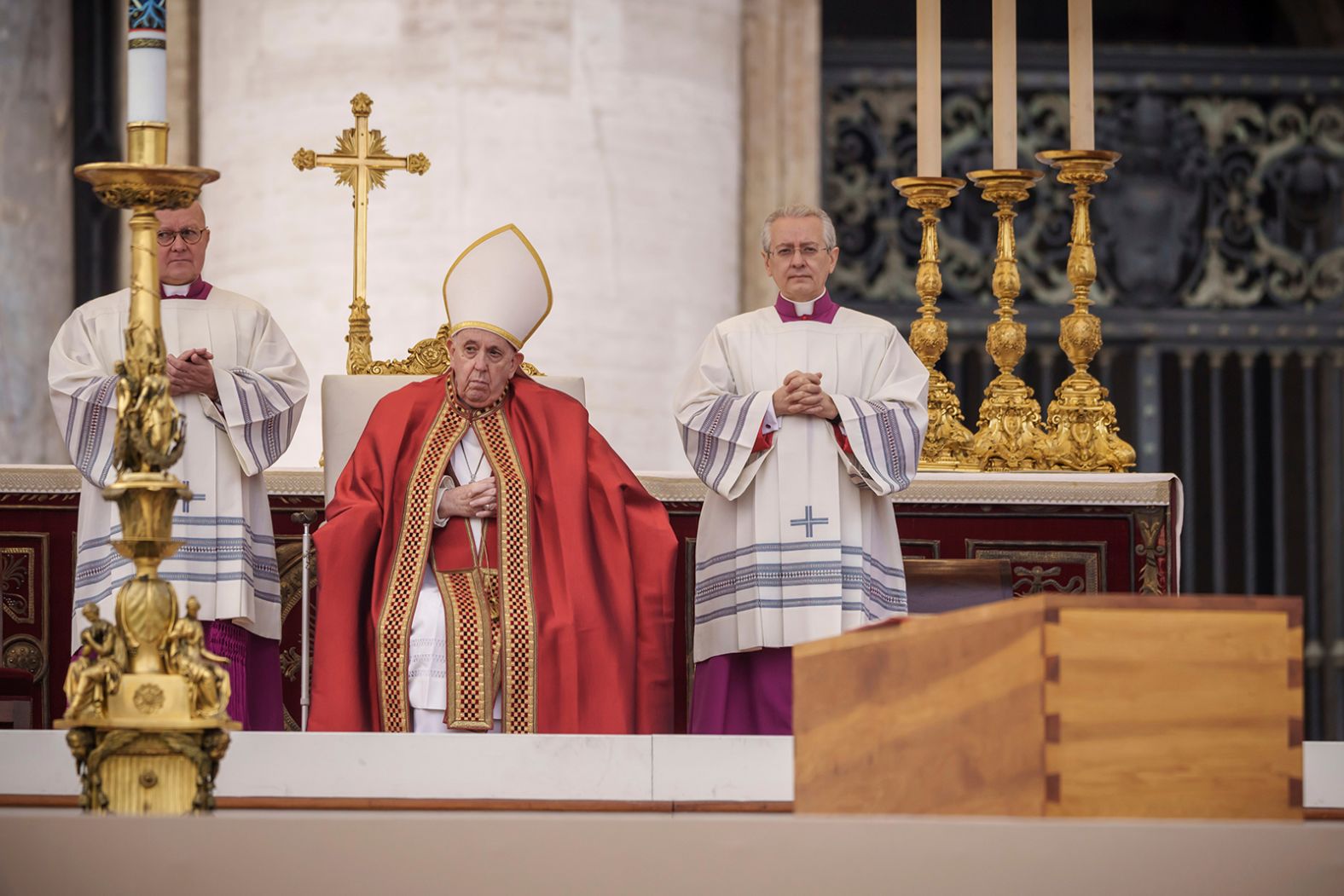 Pope Francis sits behind the coffin of the late Pope Emeritus Benedict XVI during the public funeral mass in St. Peter's Square.