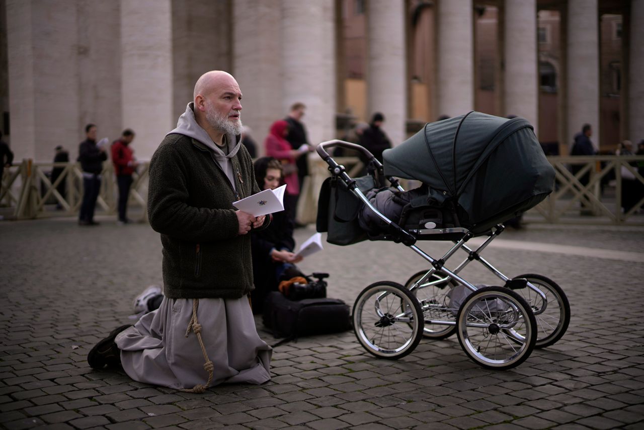 A mourner prays during the funeral service at the Vatican.