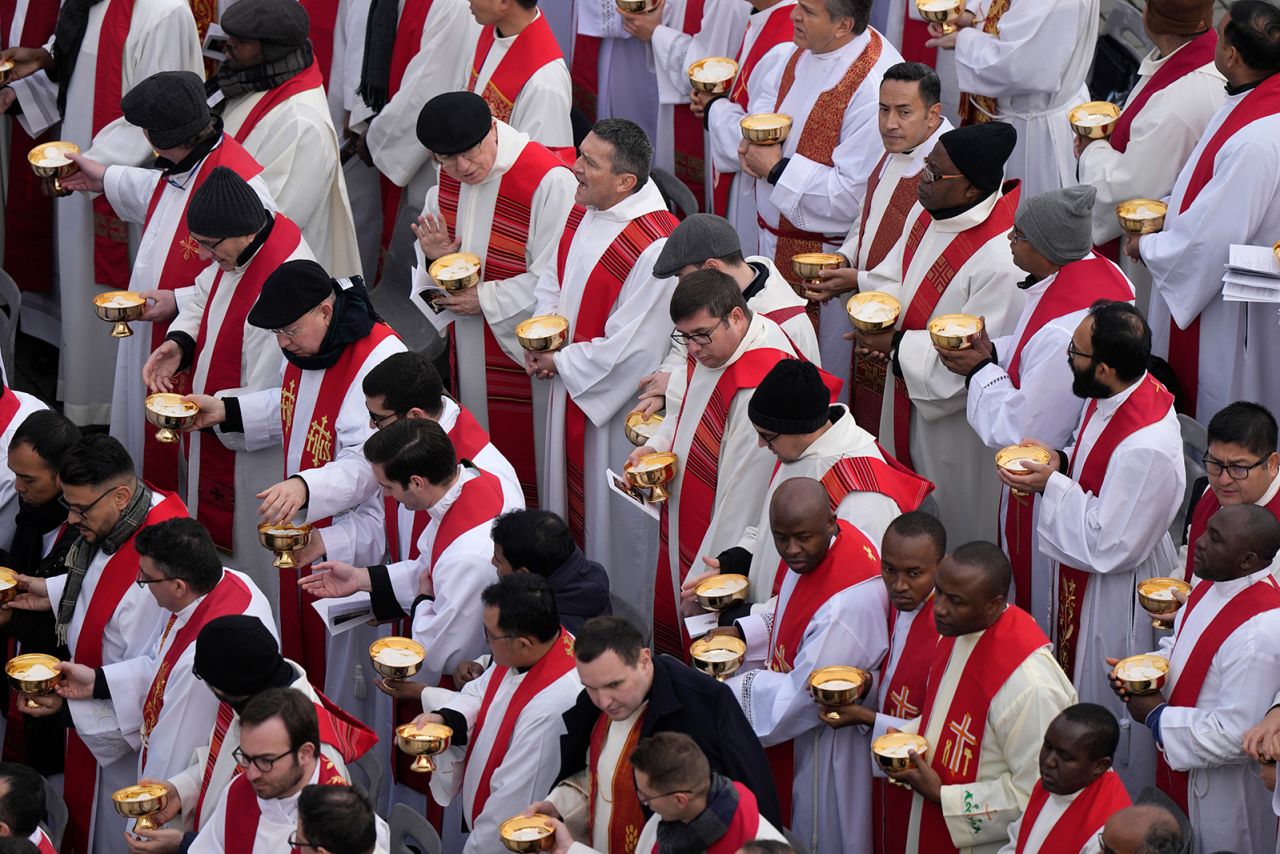 Priests prepare for the holy communion during the funeral mass.