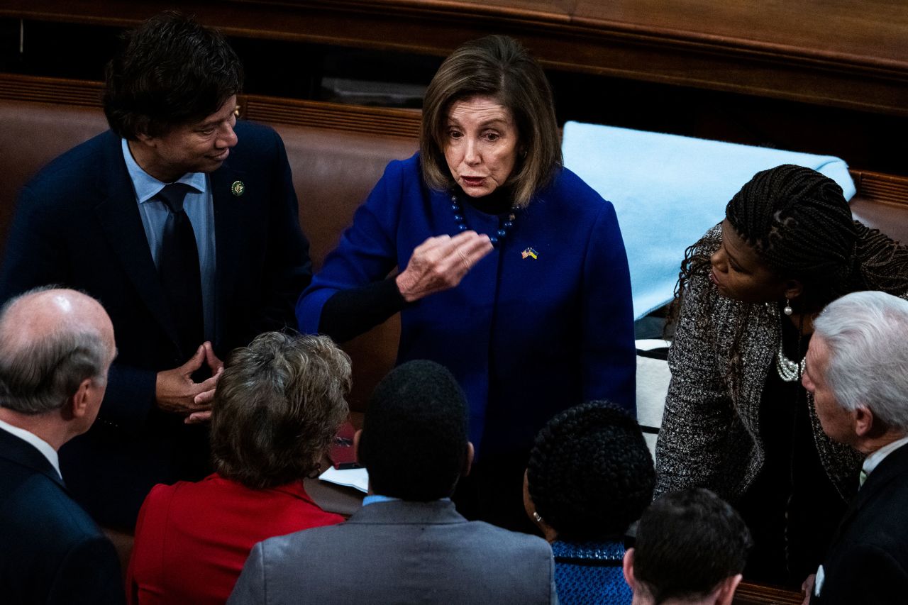 Pelosi talks to fellow lawmakers on Thursday.