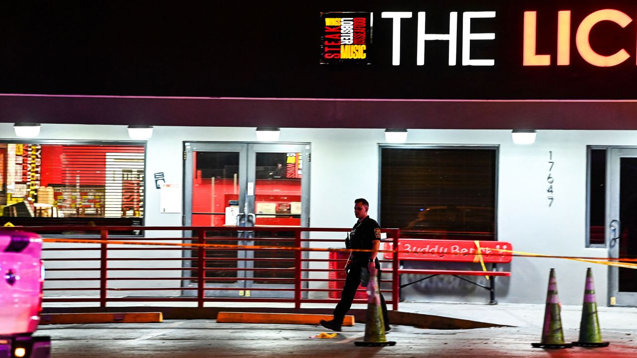 A Miami Gardens Police officer walks out of The Licking restaurant, where a shooting investigation is being held in Miami Gardens, Florida.