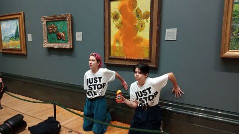 Climate protesters hold a demonstration as they throw cans of tomato soup at Vincent van Gogh's "Sunflowers" at the National Gallery in London, on October 14, 2022. 
