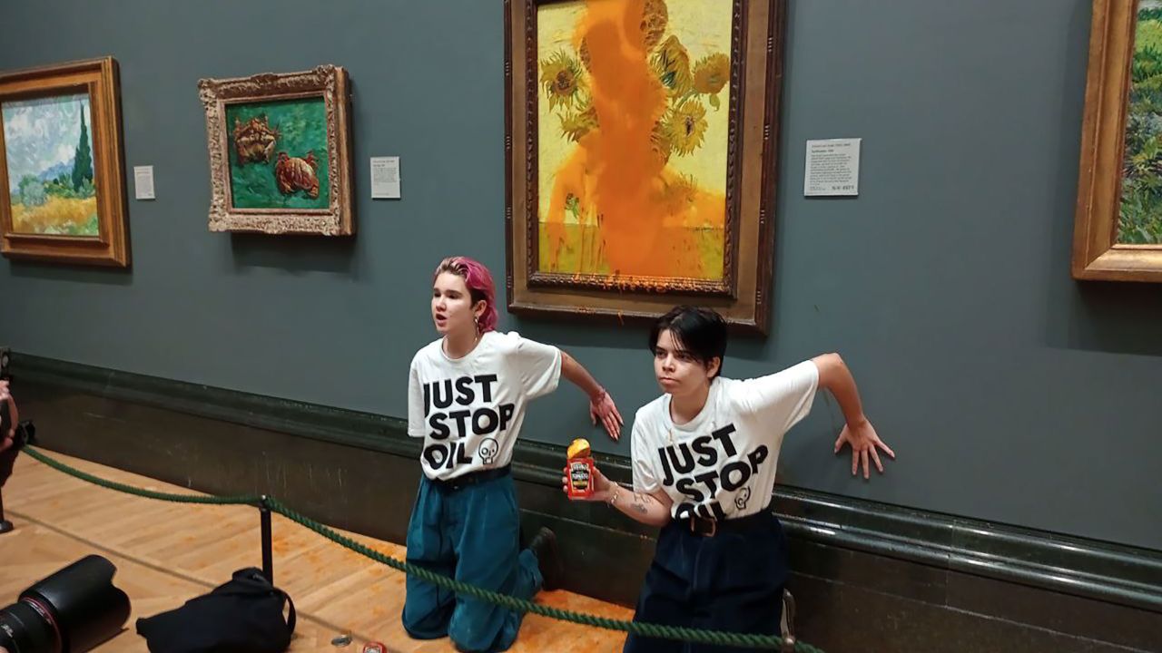 Climate protesters hold a demonstration as they throw cans of tomato soup at Vincent van Gogh's "Sunflowers" at the National Gallery in London, on October 14, 2022. 
