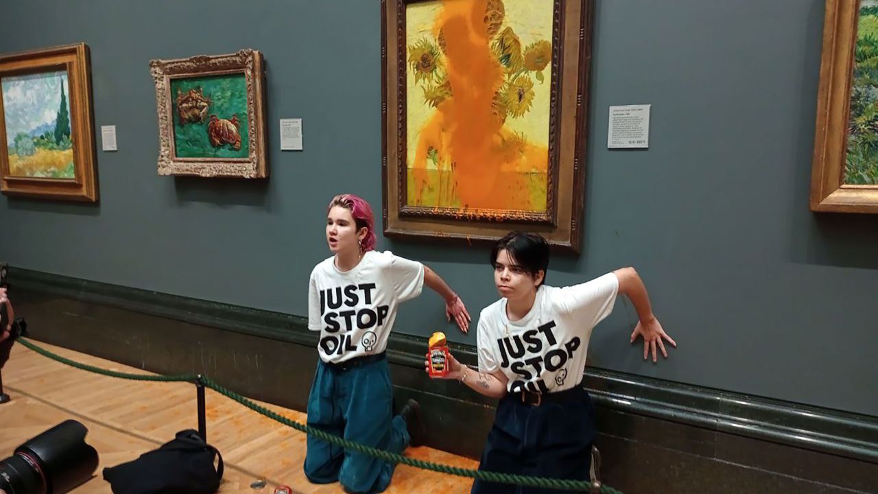 Climate protesters hold a demonstration as they throw cans of tomato soup at Vincent van Gogh's "Sunflowers" at the National Gallery in London, on October 14, 2022.