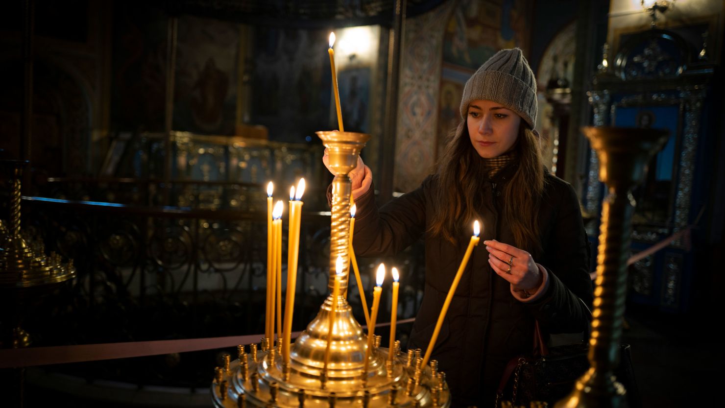A girl lights a candle before the start of the Orthodox Christmas in St. Michael's Monastery of Kyiv, Ukraine, on Friday, January 6, 2023. 