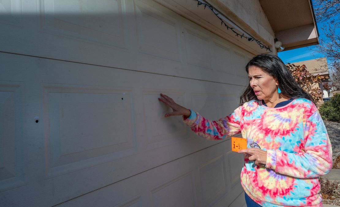 State Sen. Linda Lopez shows bullet holes in her garage door after her home was shot at last month.
