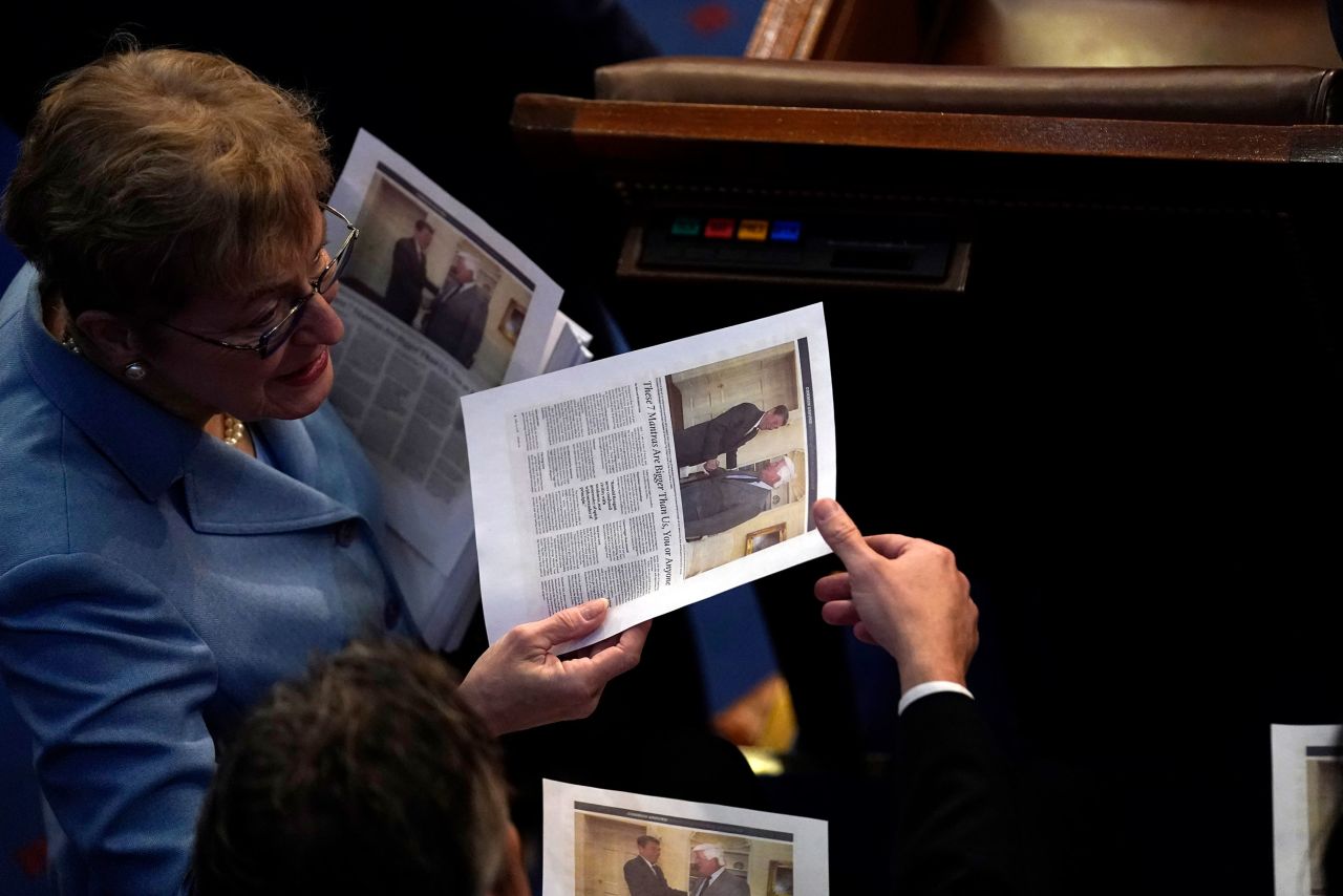 House members read a printed news article inside the chamber on Friday.