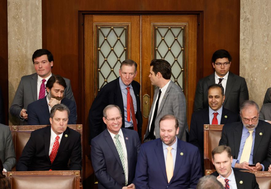 Gosar, center left, and Gaetz talk near the back of the House chamber on Friday. Gosar flipped to McCarthy at this vote. Gaetz voted against McCarthy.