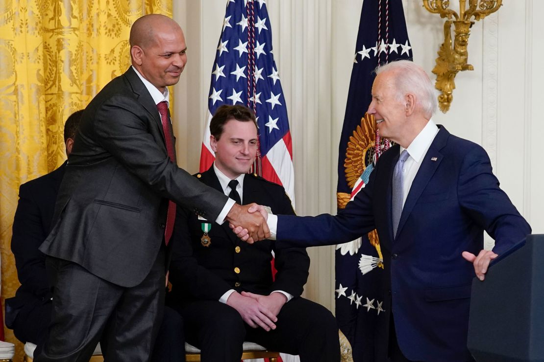 President Joe Biden shakes hands with U.S. Capitol Police Sgt. Aquilino Gonell as he speaks about Gonell in the East Room of the White House in Washington, Friday, Jan. 6, 2023, during a ceremony to mark the second anniversary of the Jan. 6 assault on the Capitol and to award Presidential Citizens Medals. Washington Metropolitan Police Department officer Daniel Hodges looks on at center. 