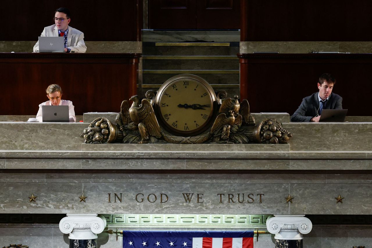 Reporters work in the press gallery that overlooks the House chamber on Friday.