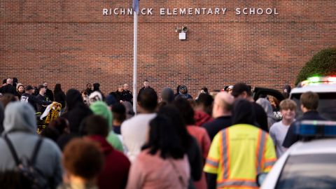 Students and police gather outside of Richneck Elementary School after a shooting, Friday, January 6, 2023, in Newport News, Virginia.