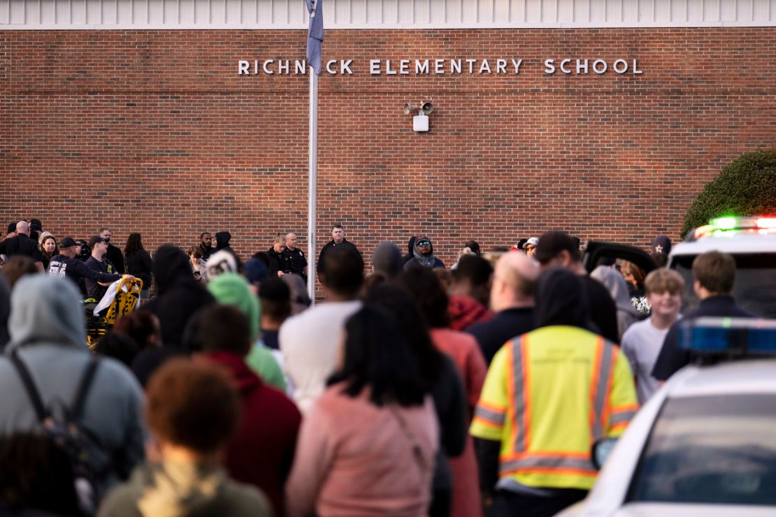 Students and police gather outside of Richneck Elementary School after a shooting, Friday, Jan. 6, 2023 in Newport News, Va.