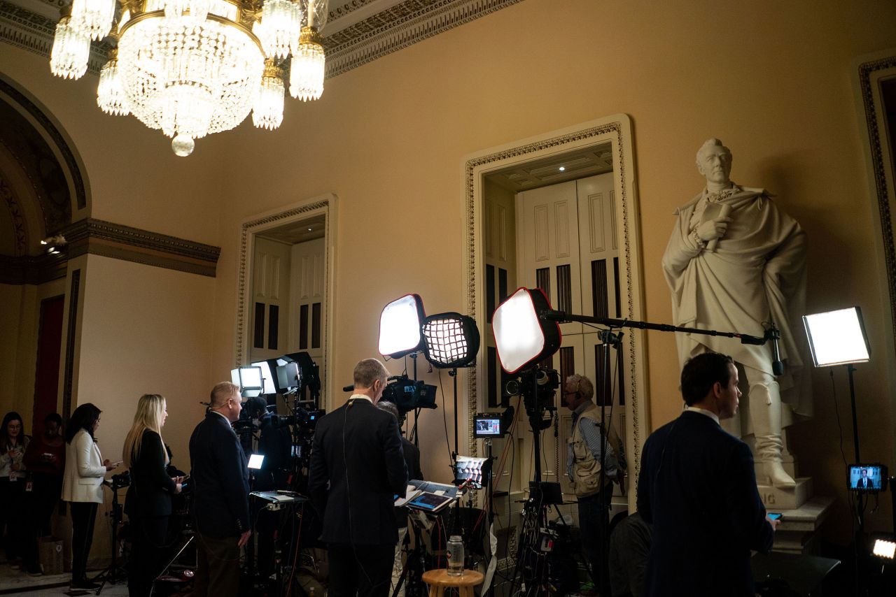 Television reporters prepare to do their stand-ups from the Capitol on Friday.